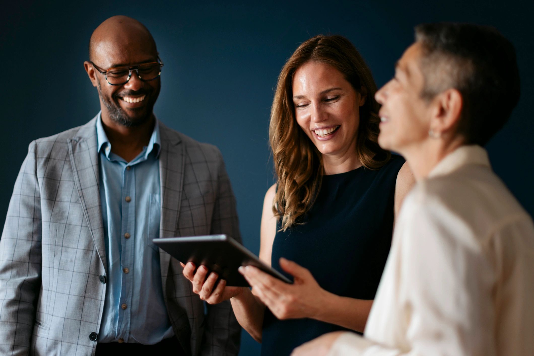 Business team collaborating on cybersecurity planning with a tablet